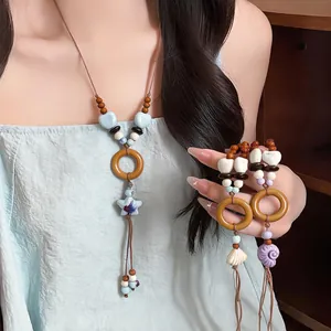 Bohemian shell and bead long necklace detail with wooden rings for seaside vacation
