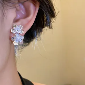 Close-up of elegant vintage silver flower stud earrings with shimmering zircon crystals