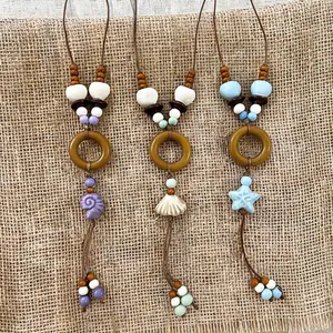 Bohemian style shell and starfish ceramic bead necklaces on natural burlap background