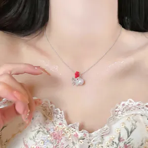 Macro detail of elegant zircon lace bow necklace with white pearl pendant worn by model