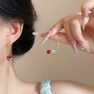 Detailed view of colorful dopamine style hoop earrings featuring vibrant red and blue beads