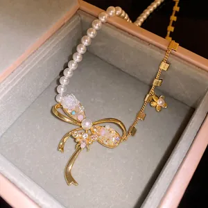 Close-up detail of vintage bow-knot necklace with pearls, bee motif, and zircon