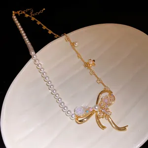 Detailed macro view of vintage court style bow pendant necklace with pearls and zircon stones