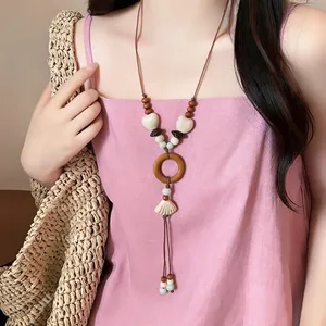 Macro view of bohemian shell necklace with wooden ring and white shell pendant