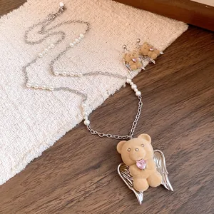 Detailed view of a cute flocked bear pendant necklace featuring wings and pink heart stone