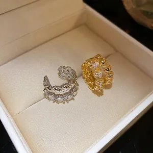Detailed macro shot of elegant vintage double-layer zircon ear cuffs inside a jewelry box