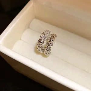 Detailed view of silver heart-shaped zircon double-layer ear cuff in a jewelry box.