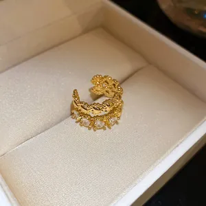 Close-up detail of vintage double-layer golden ear cuff with sparkling zircons