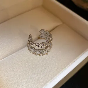 Close-up of zircon double-layer ear cuff with heart patterns in jewelry box