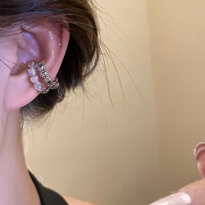 Close-up of a stylish double-layered zircon ear cuff worn on the ear bone, vintage silver finish