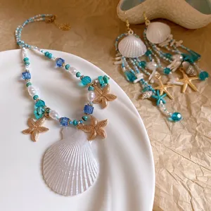 Beach vacation style jewelry set featuring white shells gold starfish and turquoise beads
