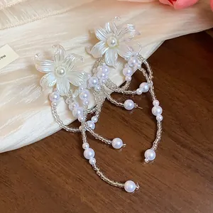 Elegant flower tassel earrings with pearls in French holiday style.