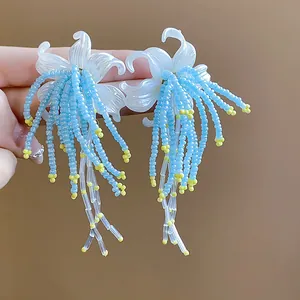 Close-up detail of elegant blue and yellow beaded tassel floral earrings for vacation style