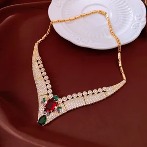 Detail of a vintage 18k gold plated necklace with large red and green zircons.