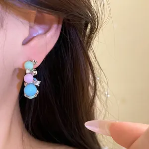 Elegant silver needle hoop earrings featuring pastel beads and sparkling rhinestones