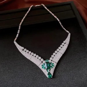 Detailed view of 18k gold plated necklace with green emerald-cut zircon centerpiece.