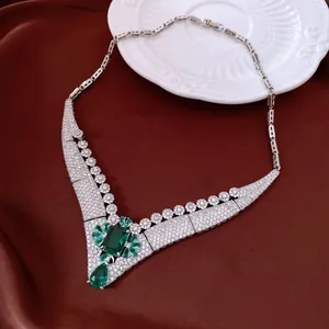 Macro detail shot of a luxury vintage palace necklace with emerald green and zircon