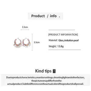 Detail view of beaded pearl hoop earrings with material and size specifications