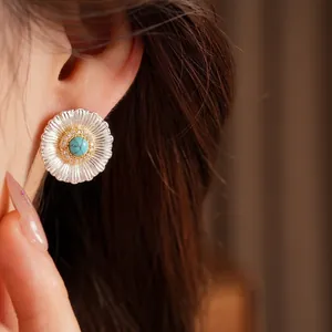 Elegant silver needle zircon flower stud earrings with turquoise center stone on model