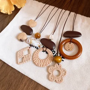 Detailed view of retro ethnic style long necklaces featuring woven pendants and wooden rings