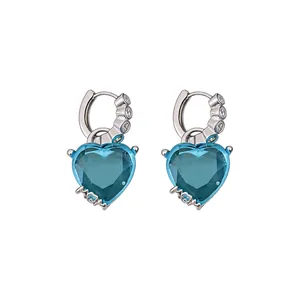 Vintage heart-shaped blue zircon huggie earrings with a silver-tone finish and clear stones.