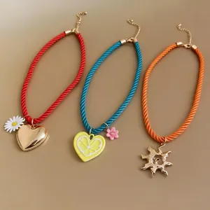 Vibrant dopamine style rope necklaces with heart, lemon, and sun pendants.