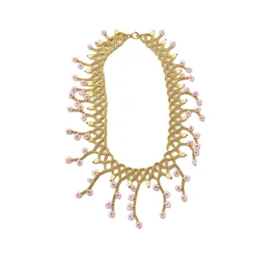 Elegant handmade beaded necklace featuring pink glass flowers and intricate gold trim