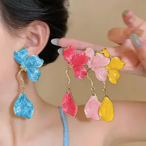 Vibrant enamel flower dangle earrings featuring multiple colors and delicate gold accents