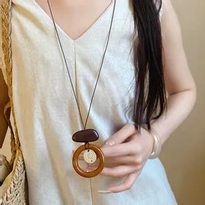 Close-up of retro ethnic style long necklace with irregular wooden ring pendant