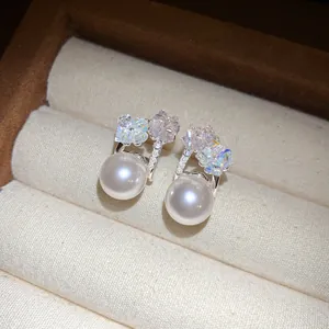 Close-up of elegant Korean fairy style earrings with pearls and iridescent stones