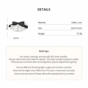Detailed view of large fabric lace bow hair clip with size and material specifications