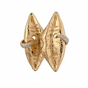 Statement gold-plated lip earrings featuring wrinkled texture and sparkling crystal accents.
