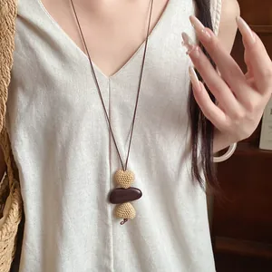 Close-up of a vintage ethnic style long necklace with irregular beads on a model