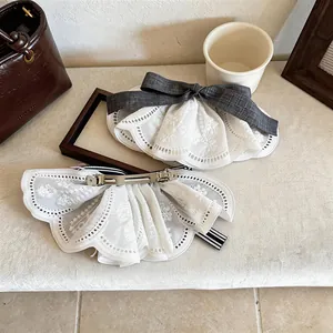 Close-up detail of elegant white lace bow hair clip with durable metal duckbill clip.