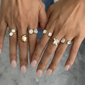 Detail view of various gold-plated stainless steel rings with clear zircon stones