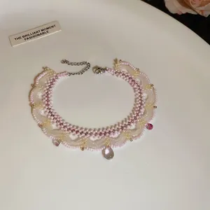 Handmade pink beaded lace necklace with glass droplets for an elegant, vintage look.