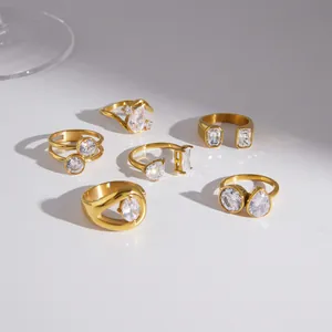 Collection of gold stainless steel rings featuring clear faceted cubic zirconia stones