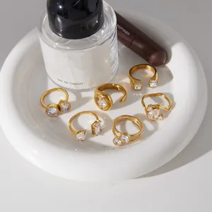 Macro view of elegant gold-plated stainless steel rings with zircons on a ceramic dish