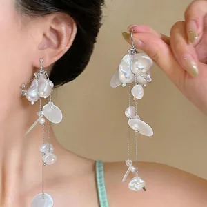 Close-up of elegant French vintage tassel earrings featuring irregular imitation pearls.
