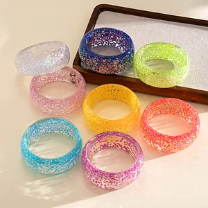 Vibrant iridescent resin bangles in multiple colors for a dopamine-style aesthetic