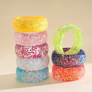 Detailed macro view of vibrant iridescent resin geometric chunky bangles stacked