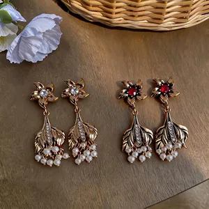 Vintage palace style gold earrings with pearls and rhinestones in fishtail design