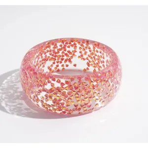 Iridescent chunky glitter resin bangle bracelet with vibrant dopamine style colors.