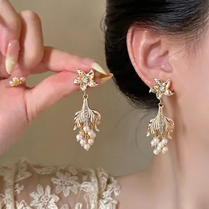 Vintage gold palace style earrings featuring elegant pearls and sparkling rhinestone accents