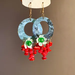 Detailed view of New Chinese Style drop earrings with marbled hoops and red coral beads