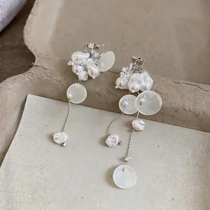 Detailed view of French vintage drop earrings with imitation pearls and shell discs