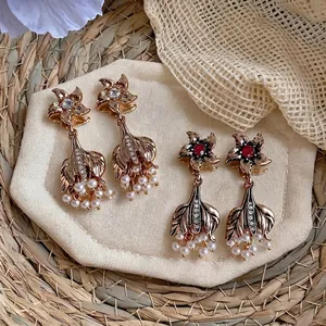 Vintage gold palace style earrings with pearls and rhinestones in fishtail design