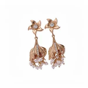 Elegant vintage gold-toned fishtail earrings with rhinestones and dangling pearls