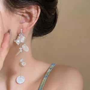 Elegant cascading pearl tassel clip-on earrings with vintage shell disc design details