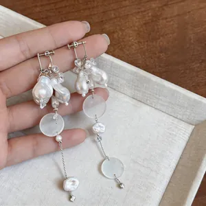 Detail view of vintage long tassel earrings with baroque pearls and crystal beads